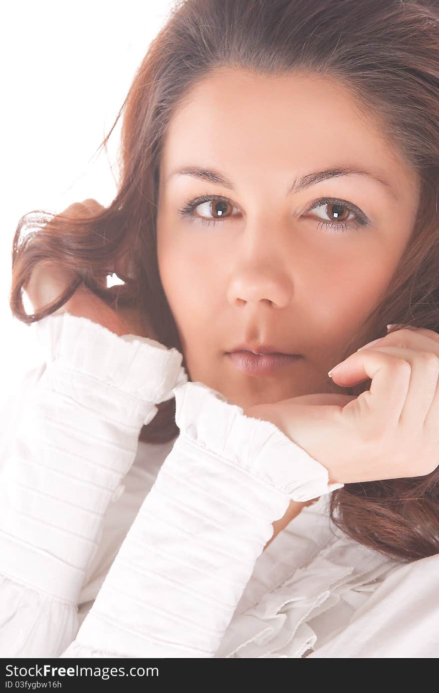 Sensual cute caucasian brunette woman standing in white shirt over pure white background.shoot made in high key technique. Sensual cute caucasian brunette woman standing in white shirt over pure white background.shoot made in high key technique.