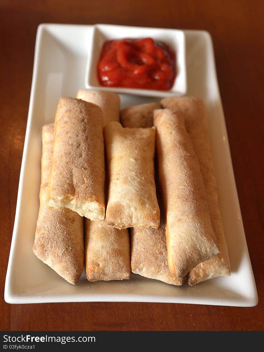 Bread sticks with tomato sauce. Very appetitive.