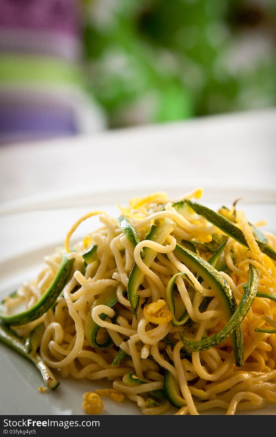 Tagliolini, a type of fresh pasta similar to spaghetti, in a courgettes and lemon sauce, portrait. Tagliolini, a type of fresh pasta similar to spaghetti, in a courgettes and lemon sauce, portrait.