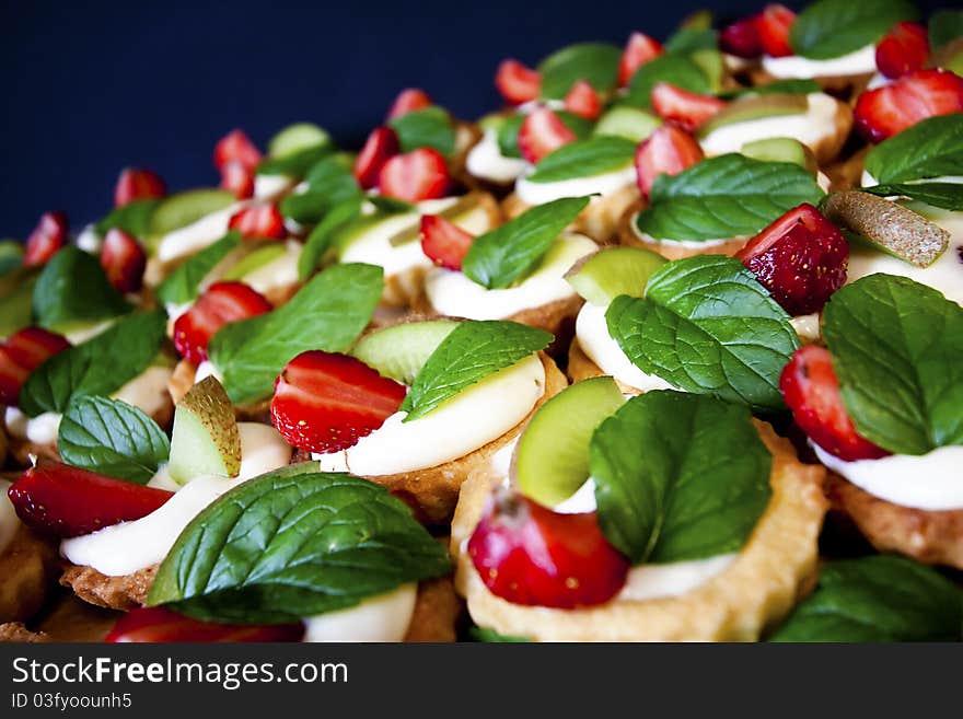 Group of sweet flans with fresh fruit and mint leaf. Group of sweet flans with fresh fruit and mint leaf