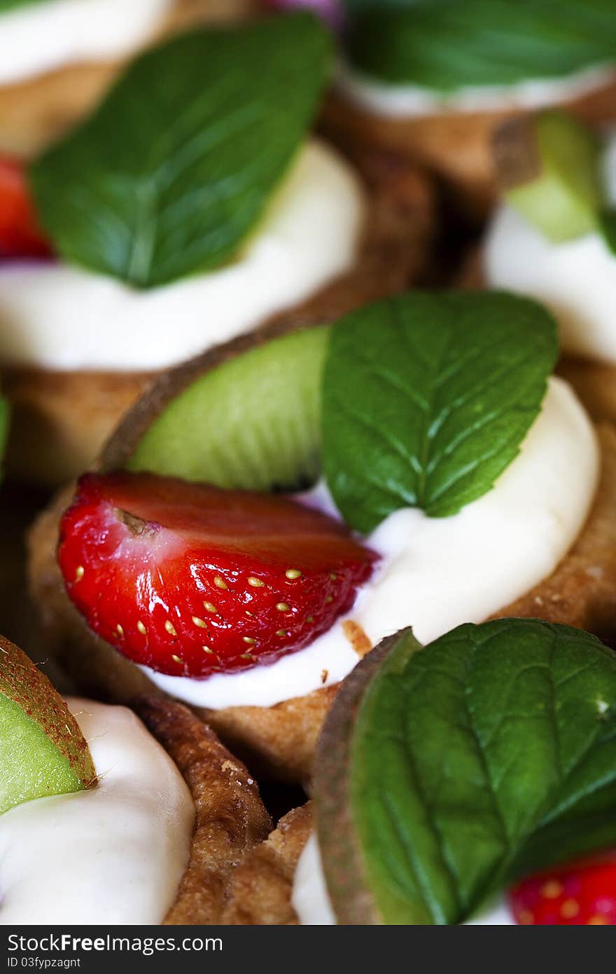 Group of sweet flans with fresh fruit and mint leaf. Group of sweet flans with fresh fruit and mint leaf