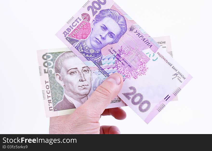 Ukrainian money is hryvnya in hand on white background