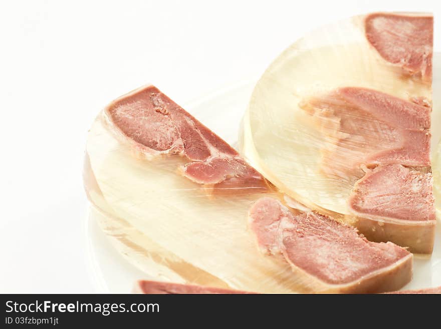 Jellied pig's tongue close-up on a plate