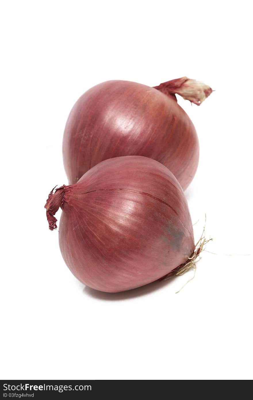 A couple of red onions isolated on a white background. A couple of red onions isolated on a white background.