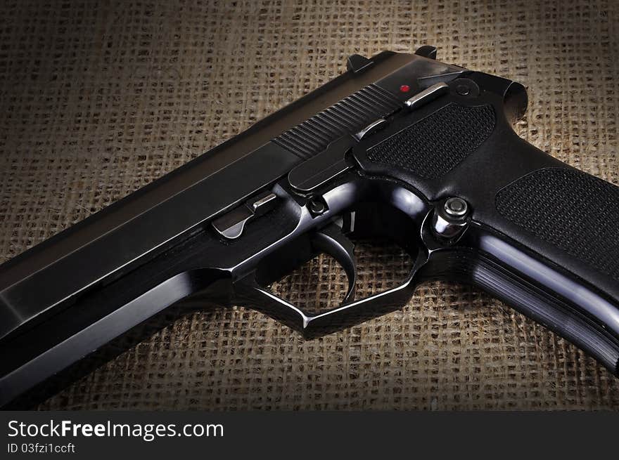 A semi-automatic pistol, photographed in a studio.