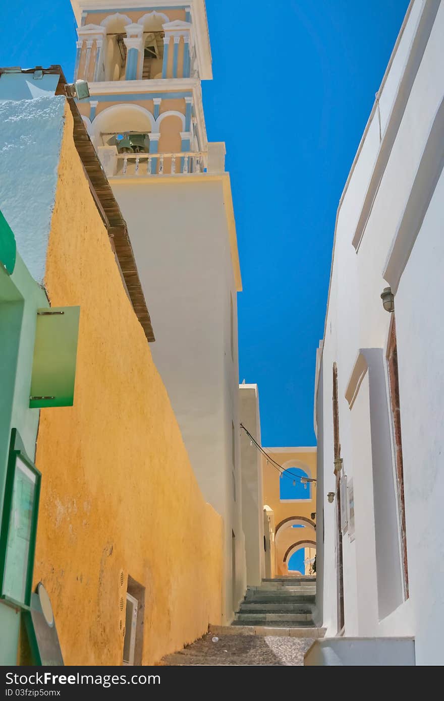 Beautiful empty street and traditional architecture with belfry on island of Santorini in Fira, Greece. Beautiful empty street and traditional architecture with belfry on island of Santorini in Fira, Greece.