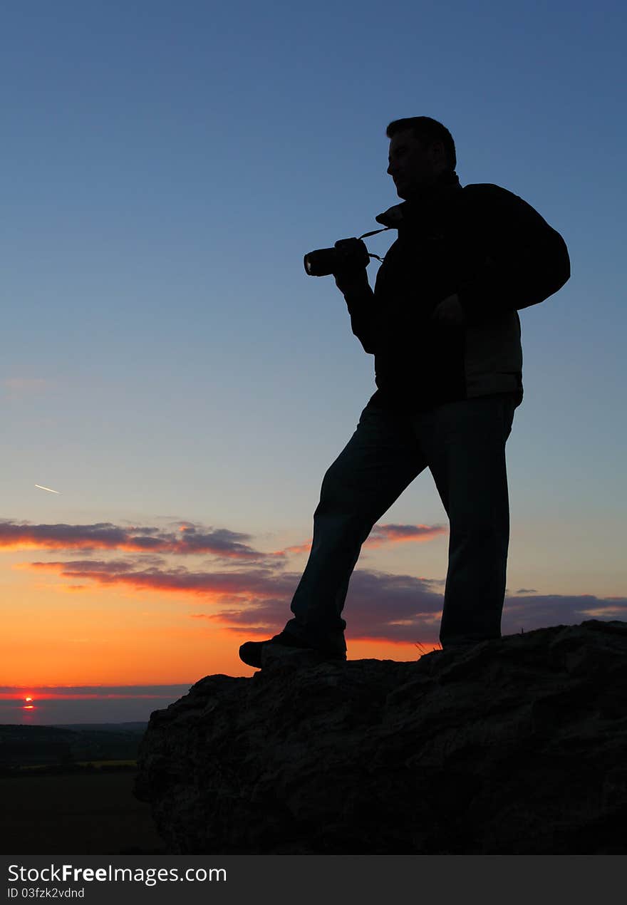 Photographer's silhouette at nice sunset. Photographer's silhouette at nice sunset.