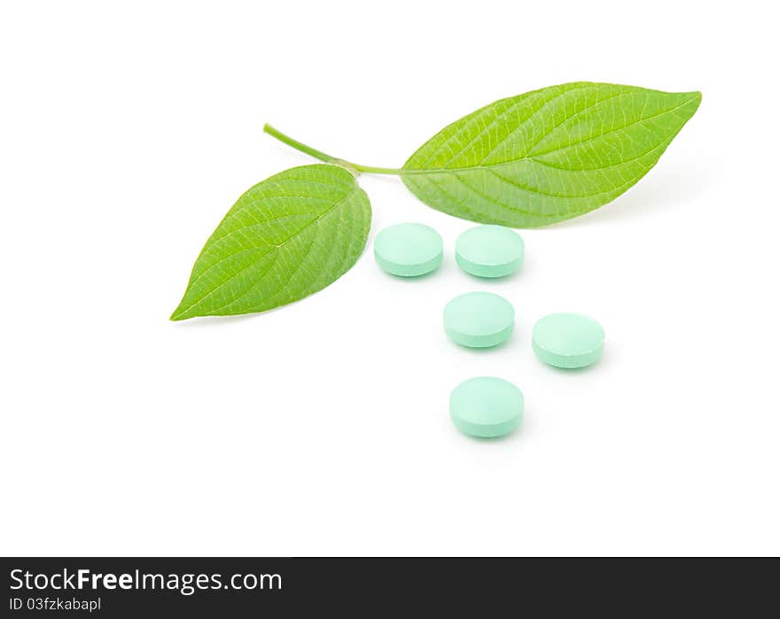 Pills with green leaf isolated on a white background. Herbal Medicine.