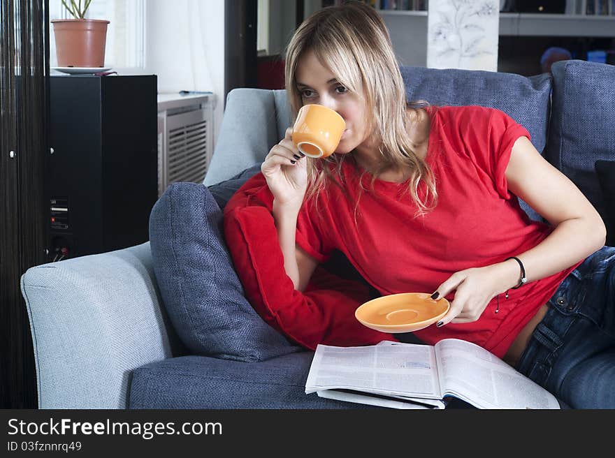 Beautiful blond woman having her morning coffee