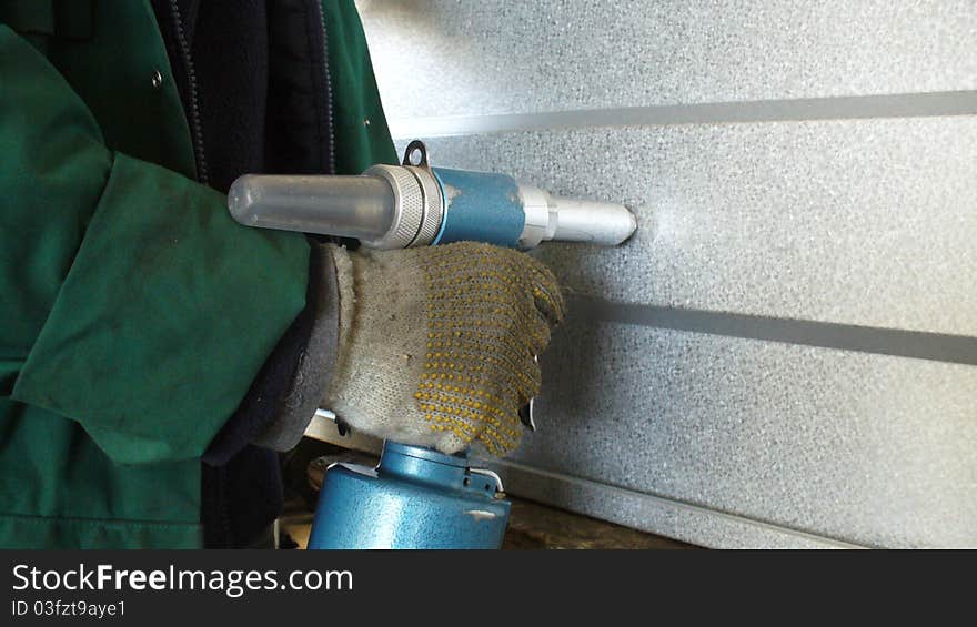 Man using a rivet gun