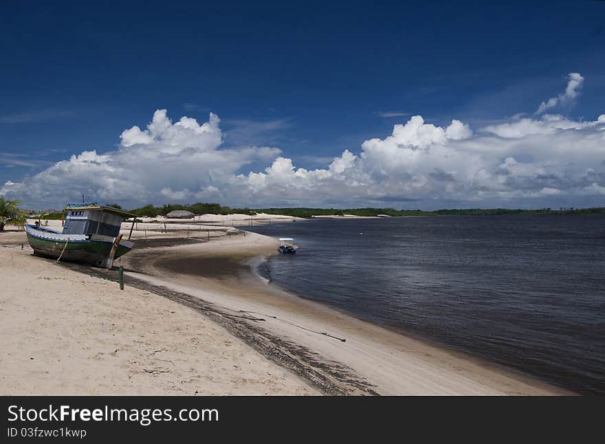 The CaburÃ© beach in Barreirinhas town, at the PreguiÃ§a river mouth, MaranhÃ£o State, Brazil. A wild and small sand strip between the beach and the river. 02Â° 34' 37 S 42Â° 41' 55 W. The CaburÃ© beach in Barreirinhas town, at the PreguiÃ§a river mouth, MaranhÃ£o State, Brazil. A wild and small sand strip between the beach and the river. 02Â° 34' 37 S 42Â° 41' 55 W