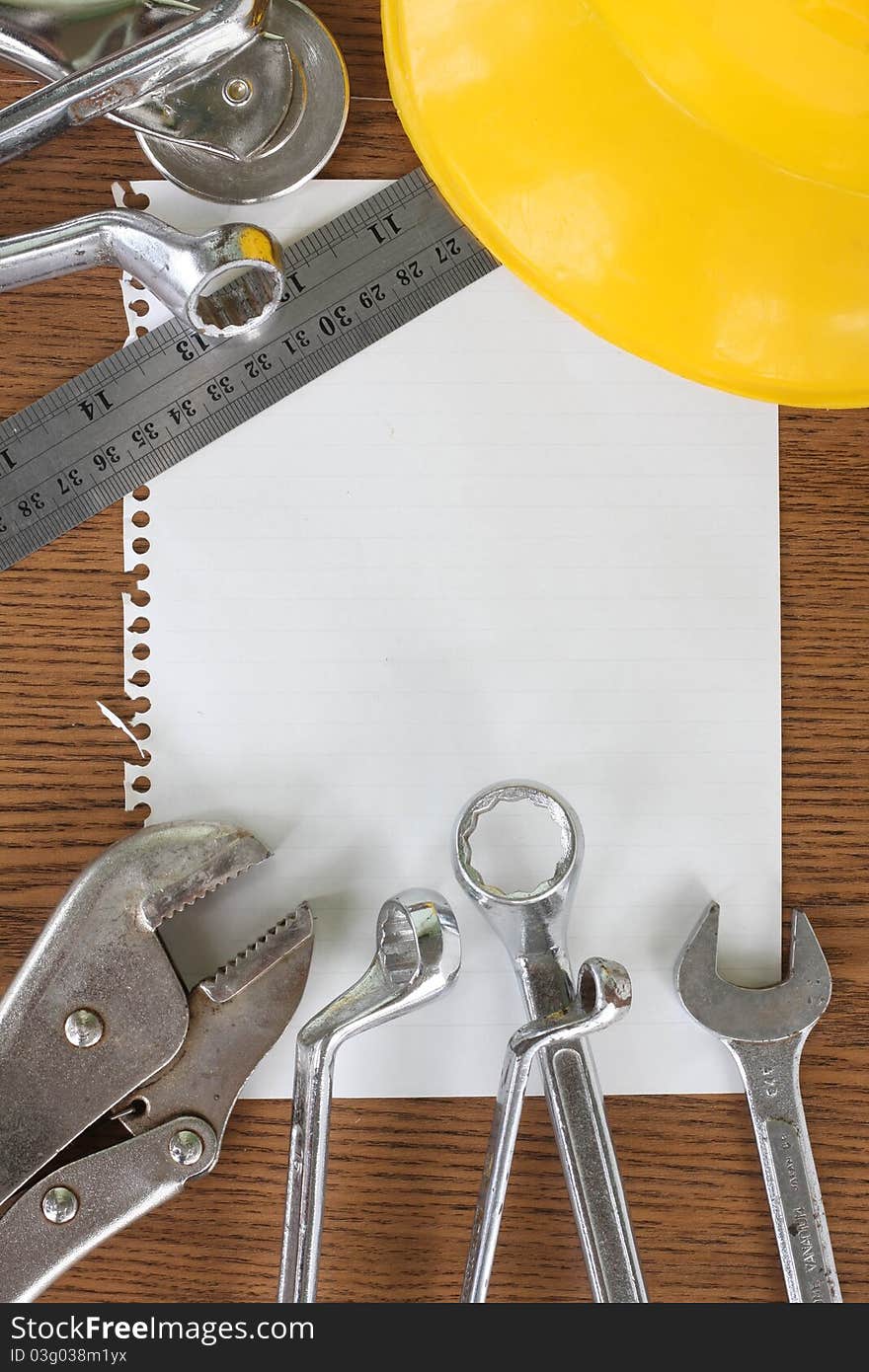 Paper not and many tool on wood background. Paper not and many tool on wood background