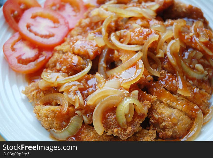 Image of pork chop with sauce tomato