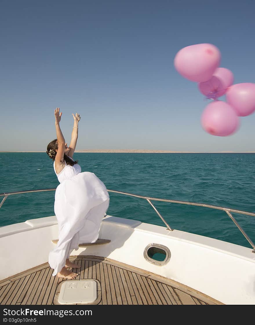 Bride releasing balloons from a boat