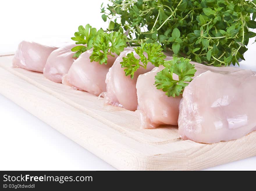 Raw chicken breasts on chopping board