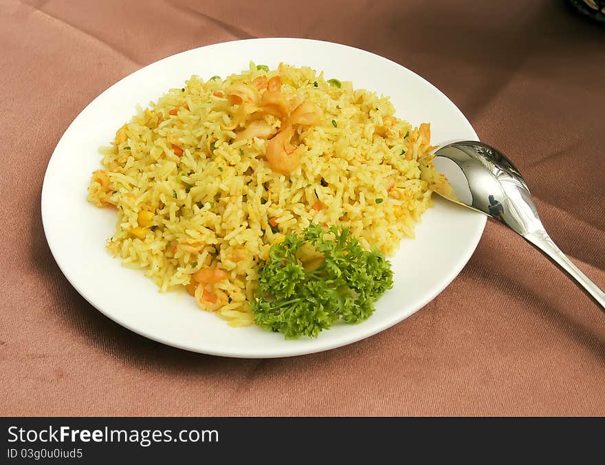 Eating fried rice using a spoon isolated in solid white background.