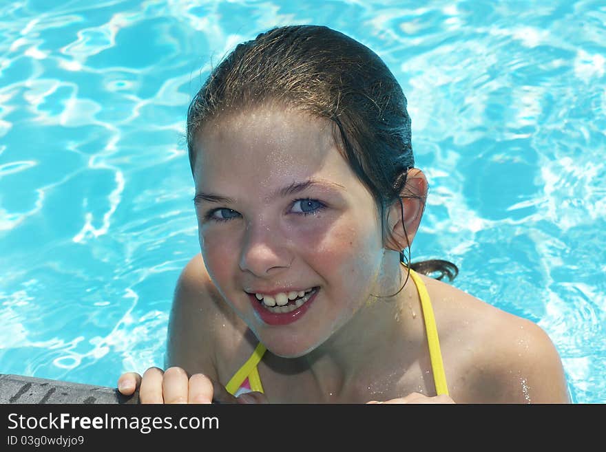 Young happy girl in the pool during summertime. Young happy girl in the pool during summertime