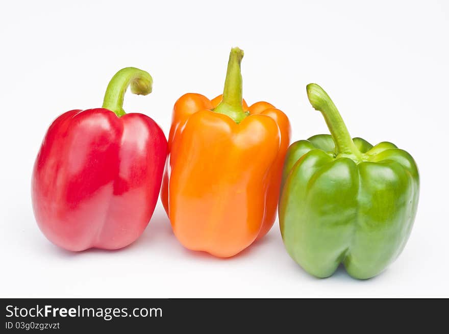 Three Peppers, red, orange & green on a white background. Three Peppers, red, orange & green on a white background