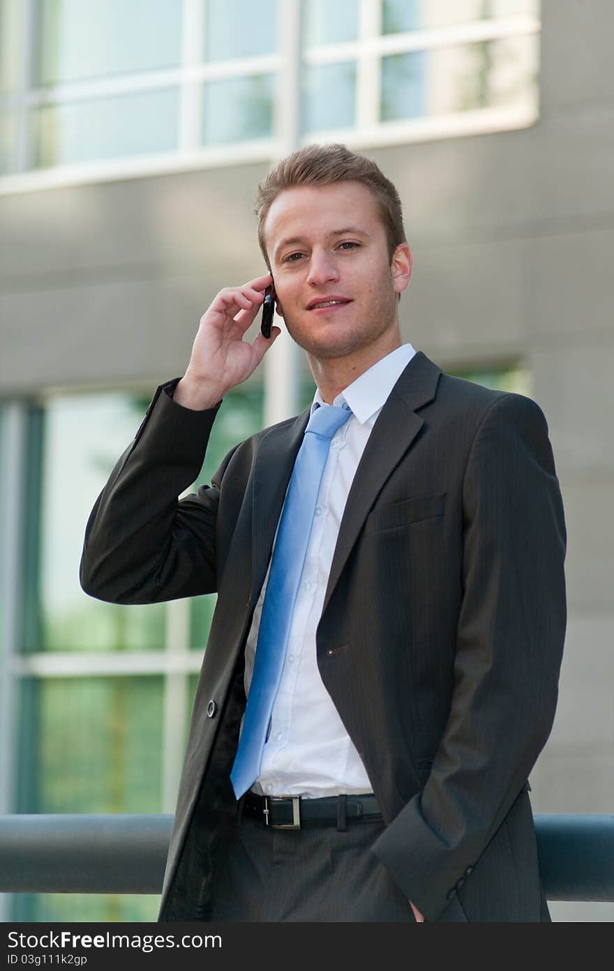 Young business man with a telephon at an office district