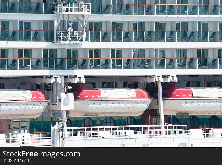 A maintenance in progress for a passenger cruise ship. This picture shown rows and levels of balcony class room and rows of safety boat.