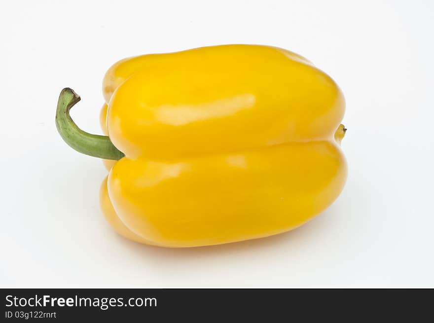 Single yellow pepper on a white background