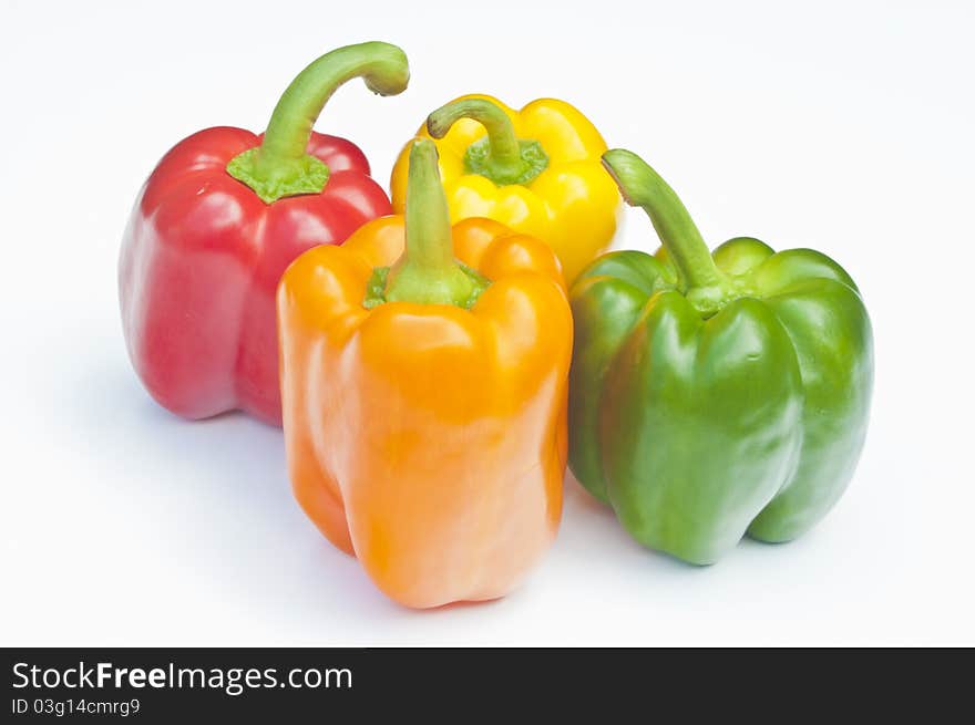 Four Peppers, red, yellow, orange & green on a white background. Four Peppers, red, yellow, orange & green on a white background