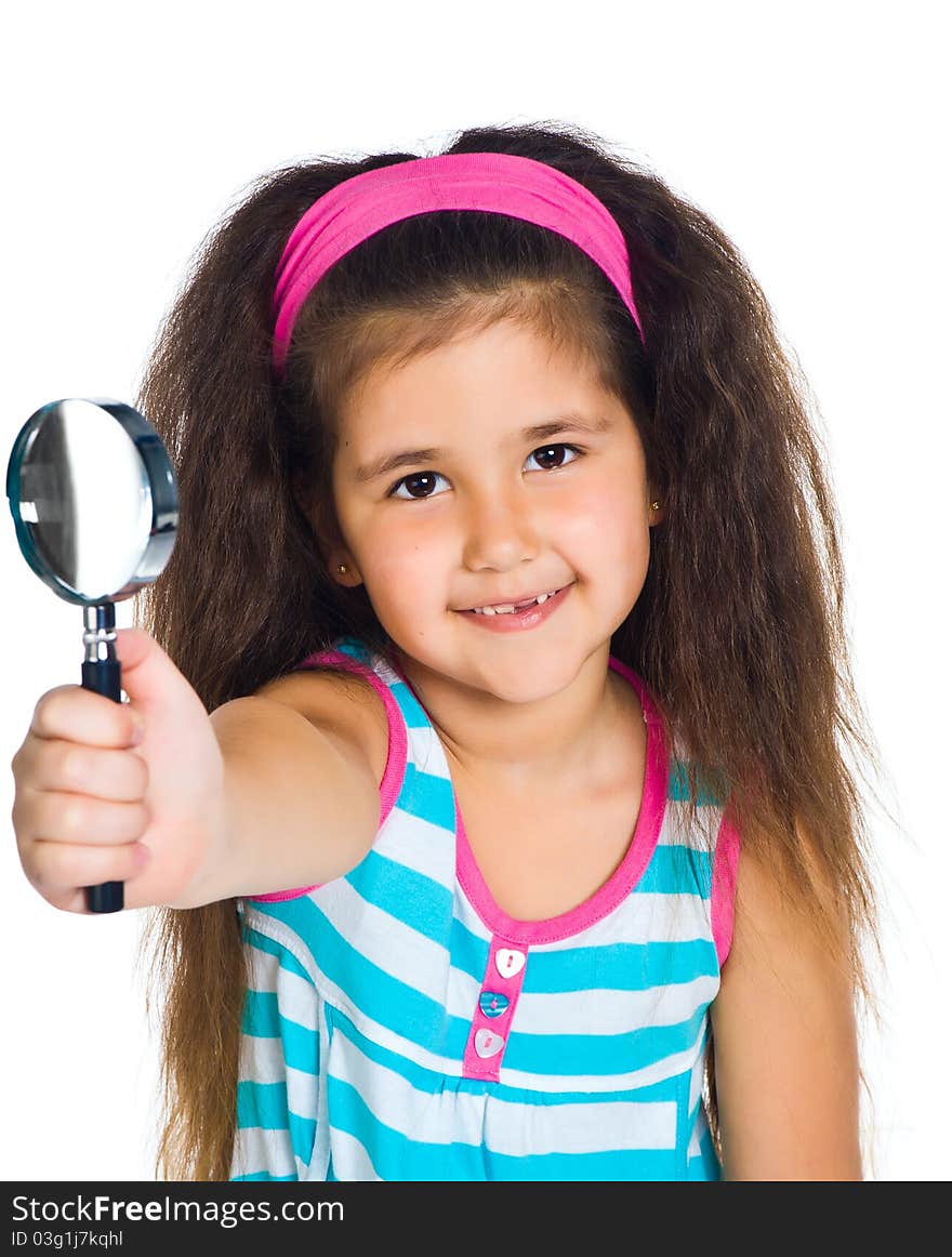 Beautiful little girl looking through a magnifying glass. Beautiful little girl looking through a magnifying glass