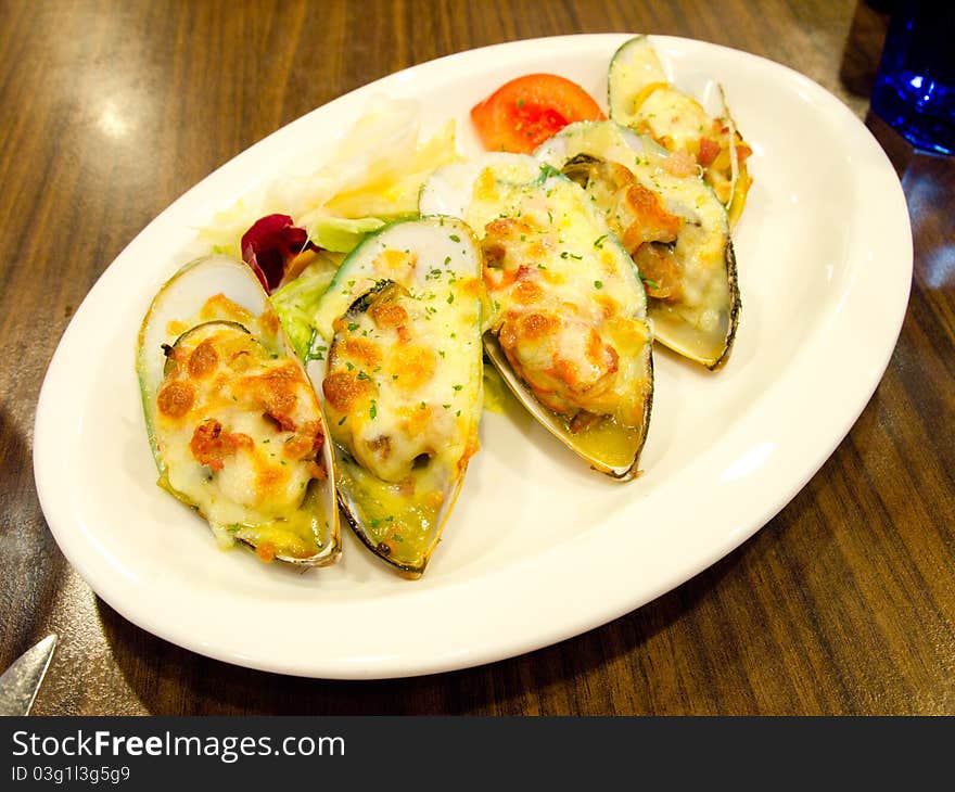 Mussels with cheese served on table. Mussels with cheese served on table