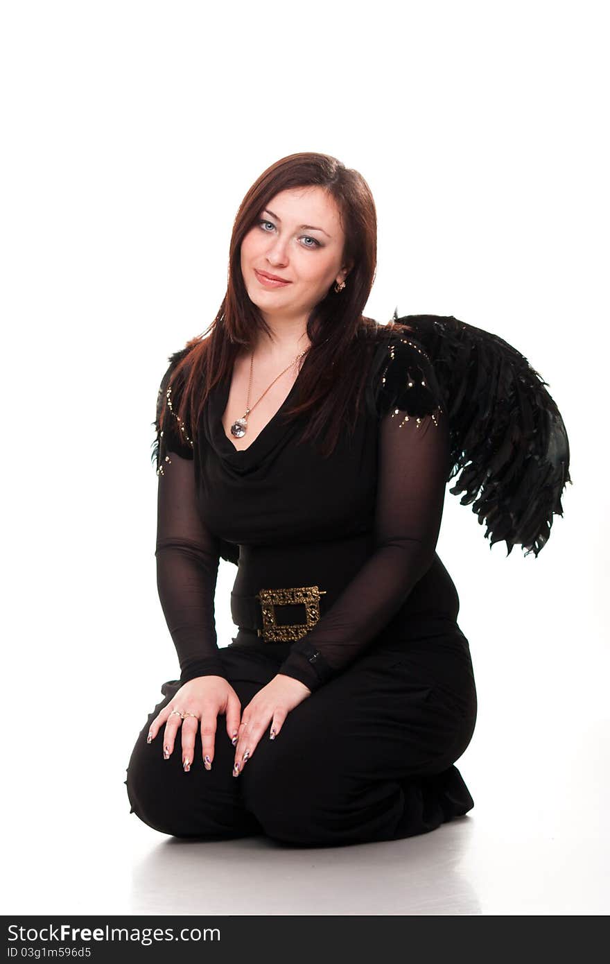 Beautiful woman in black wings sitting pensive