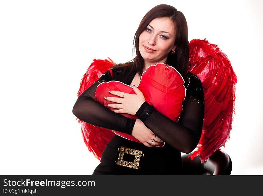 Beautiful woman with red heart in red angel wings isolated on white