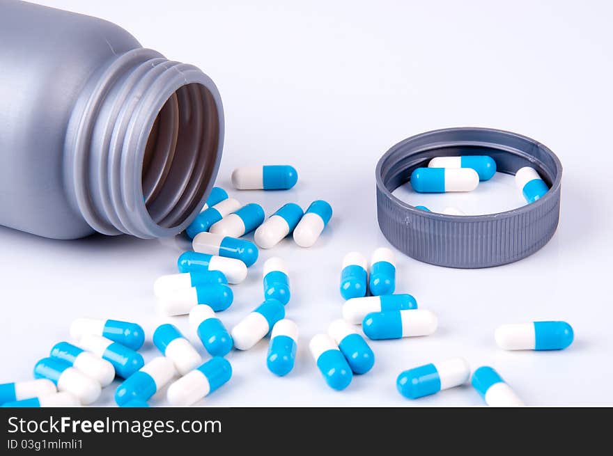 blue and white capsules of the medicament in open plastic packaging. blue and white capsules of the medicament in open plastic packaging