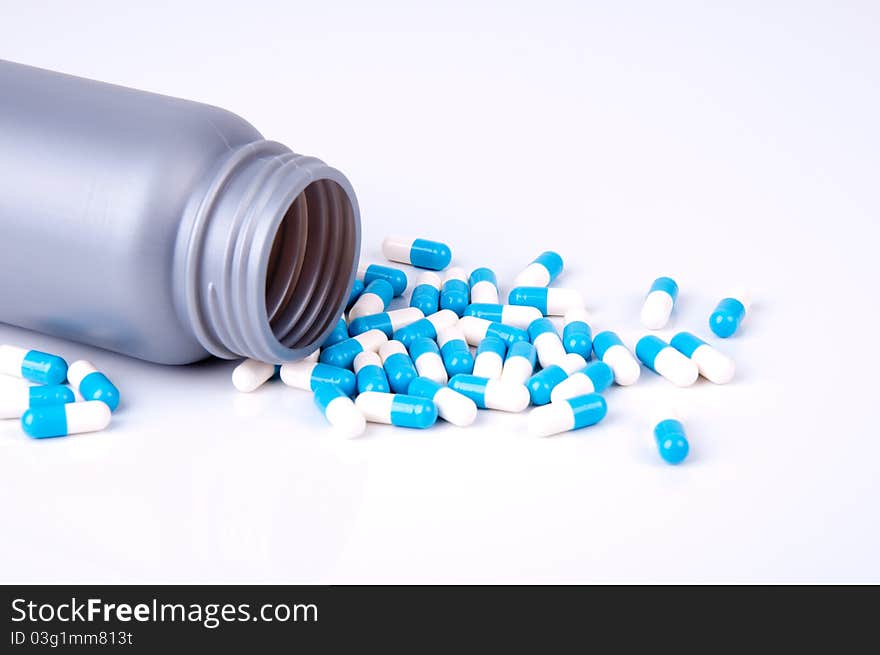 Plastic container with the medicament in capsules blue and white. Plastic container with the medicament in capsules blue and white