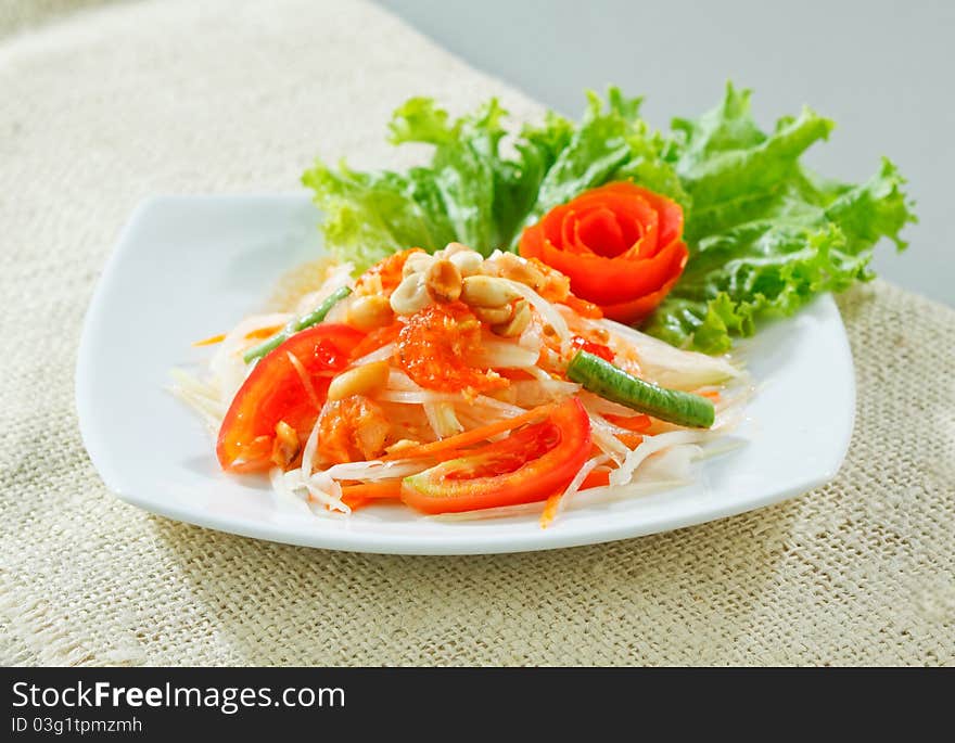 Papaya salad thai style one of Thai favorite spicy menu that you could find in everywhere in Thailand, an image isolated on white. Papaya salad thai style one of Thai favorite spicy menu that you could find in everywhere in Thailand, an image isolated on white