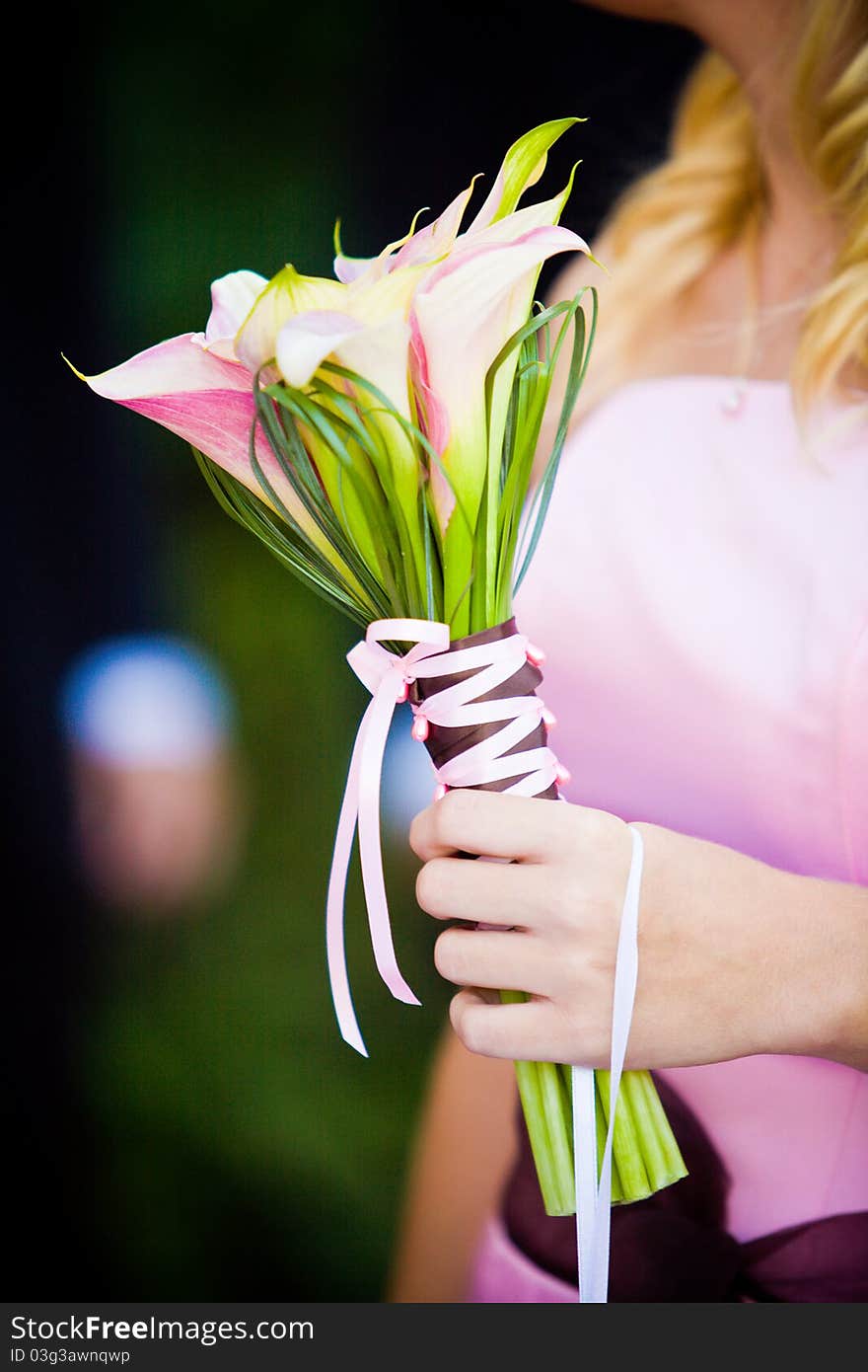 A bridesmaid holding her bouquet at a wedding