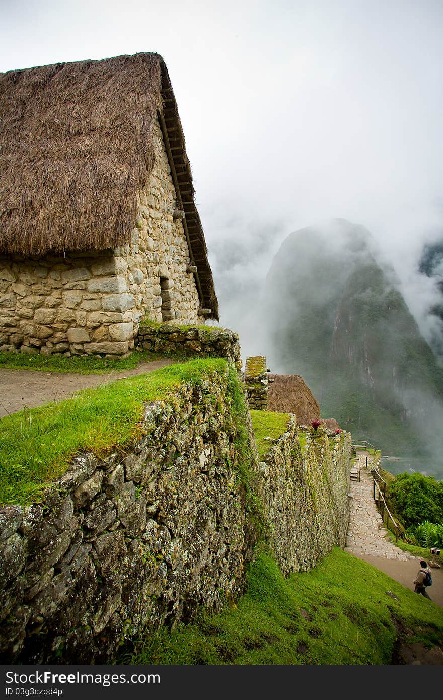 A cobble stone house on a mountain at Machu Picchu in Peru. A cobble stone house on a mountain at Machu Picchu in Peru