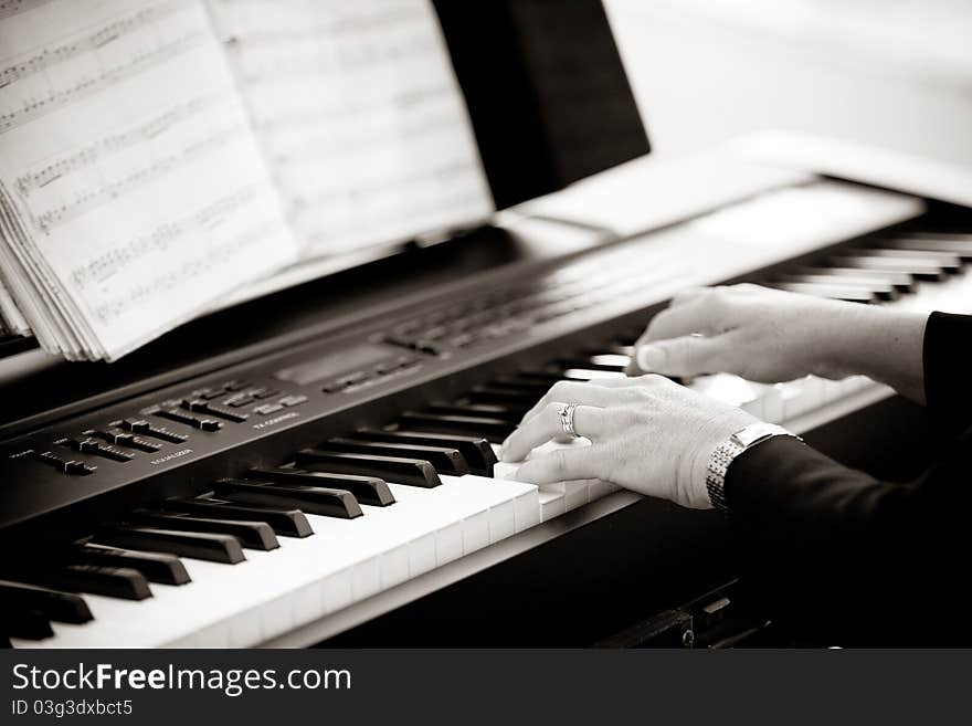 A close up of a woman playing the keyboard