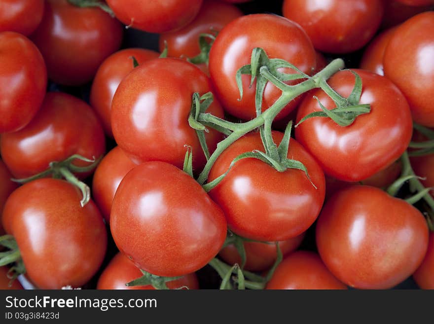 Close up of tomatoes for sale on market stall. Close up of tomatoes for sale on market stall