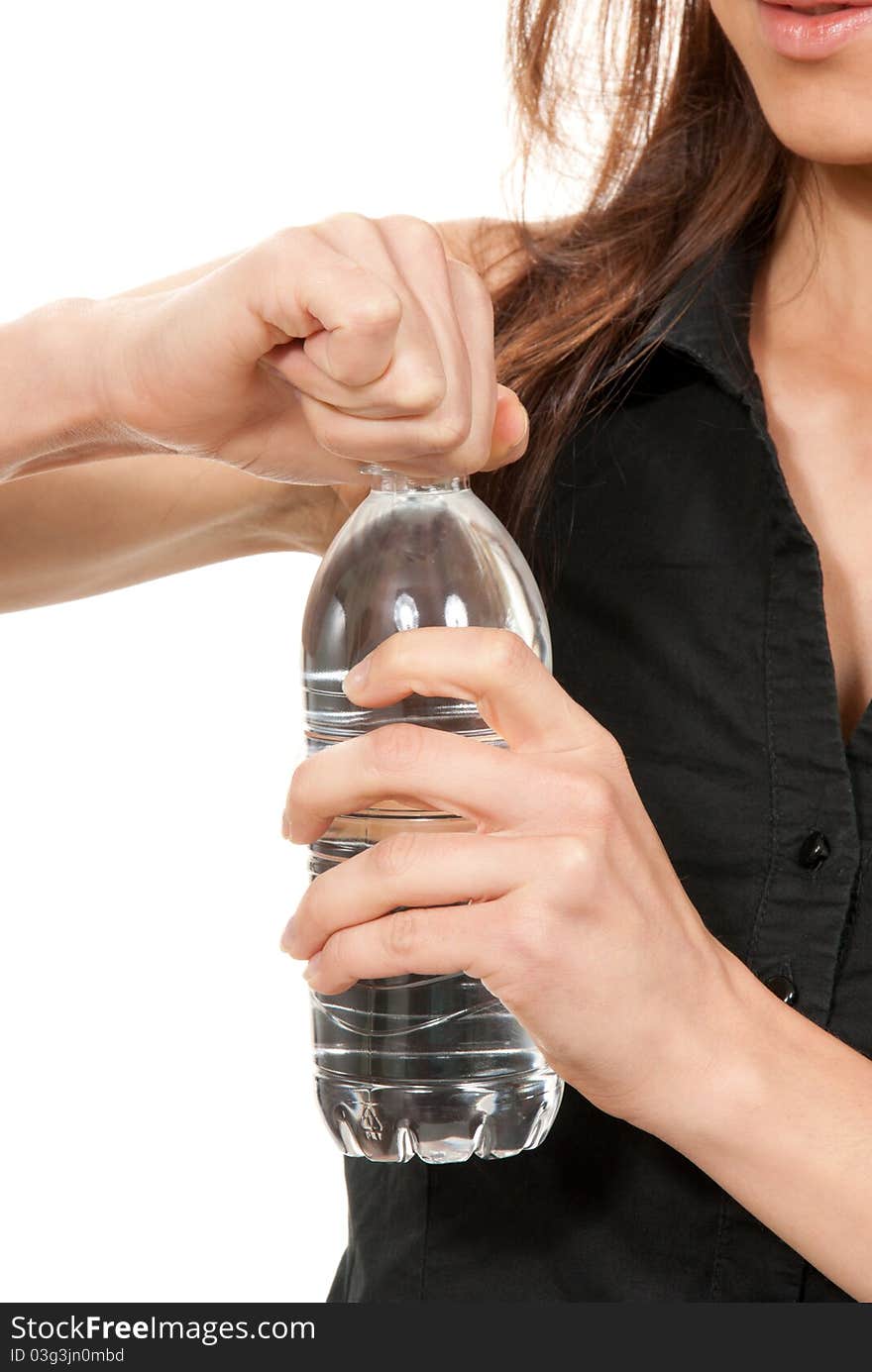 Fitness woman open drinking sparkling mineral  bottled  water isolated on a white background. Fitness woman open drinking sparkling mineral  bottled  water isolated on a white background