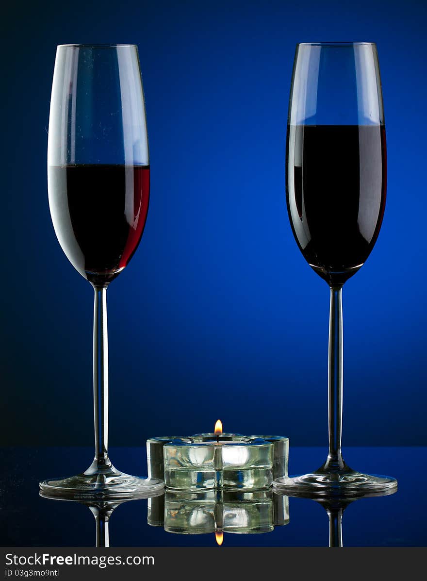 Glass of wine in studio on blue background