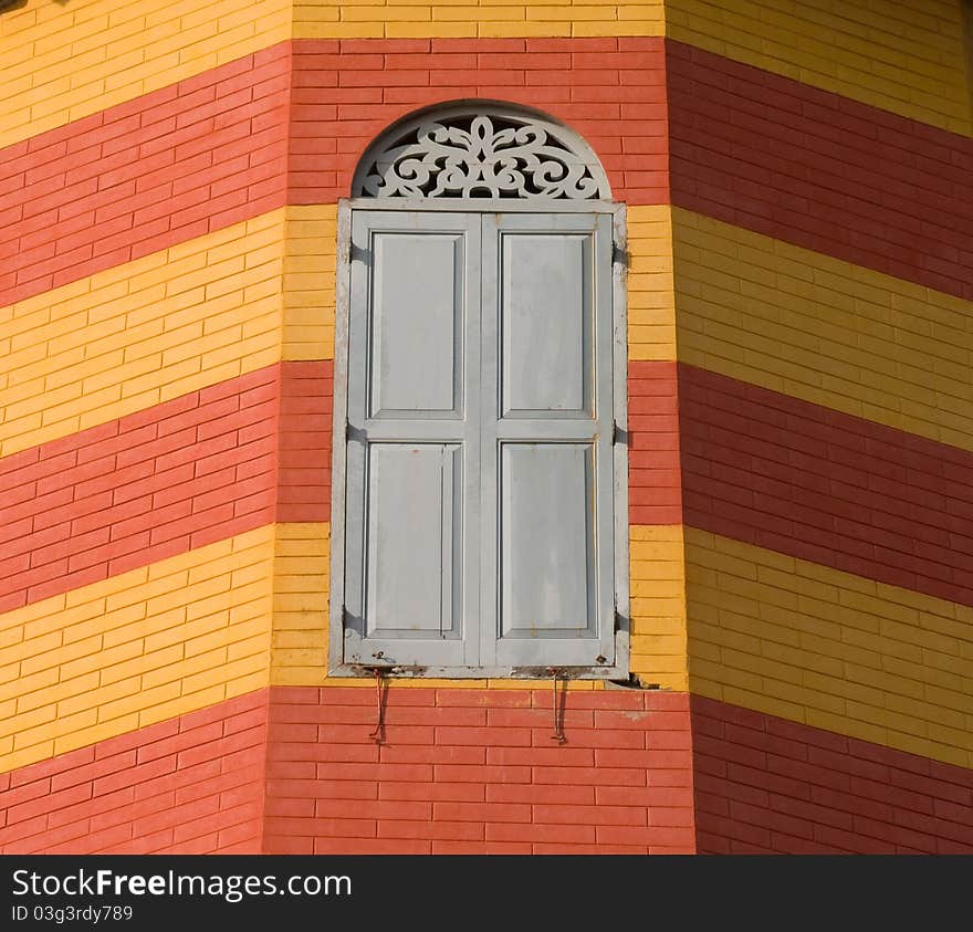 Old window on red and yellow brick wall at Bang Pa In Palace Ayutthaya province Thailand. Old window on red and yellow brick wall at Bang Pa In Palace Ayutthaya province Thailand