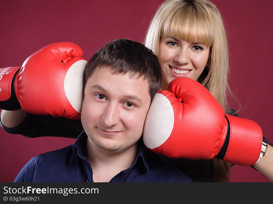 Attractive Family Couple In  Boxing Gloves On Red