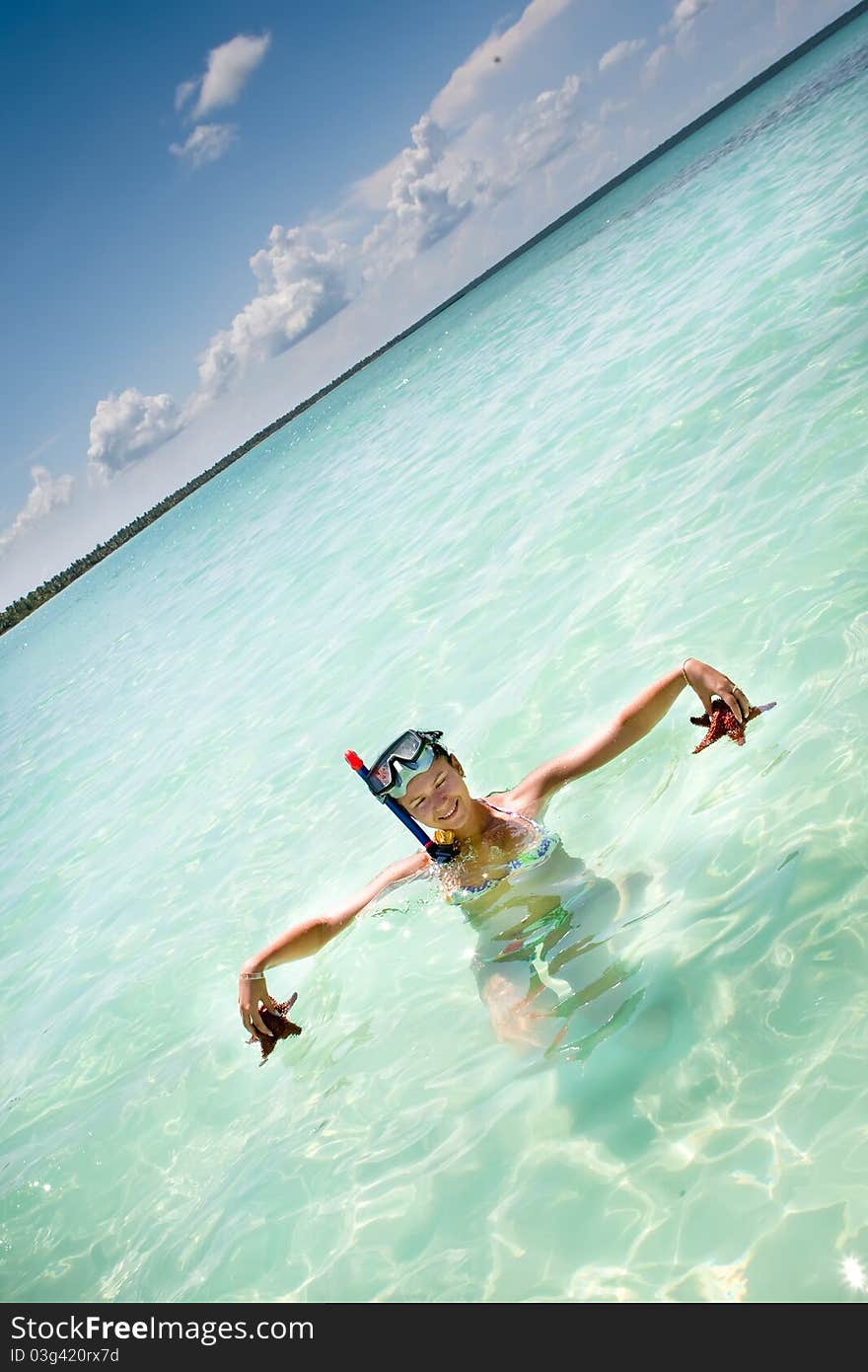 Tanned women hold in hands starfish ocean