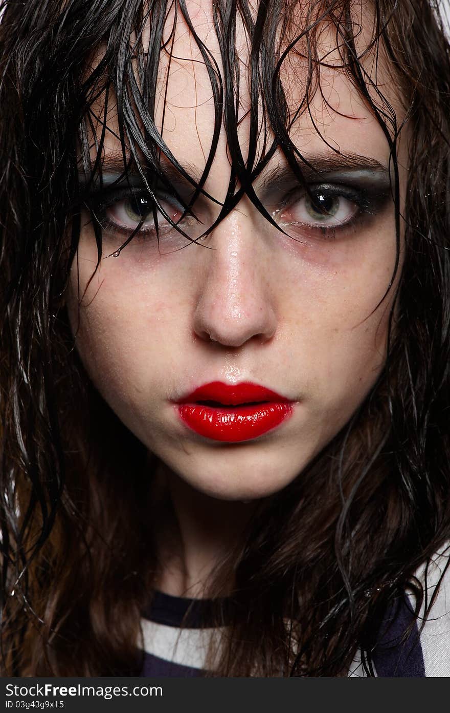 Close up portrait of beauty young girl with wet hairs and face with red glossy lipstick, bright makeup in studio. Close up portrait of beauty young girl with wet hairs and face with red glossy lipstick, bright makeup in studio