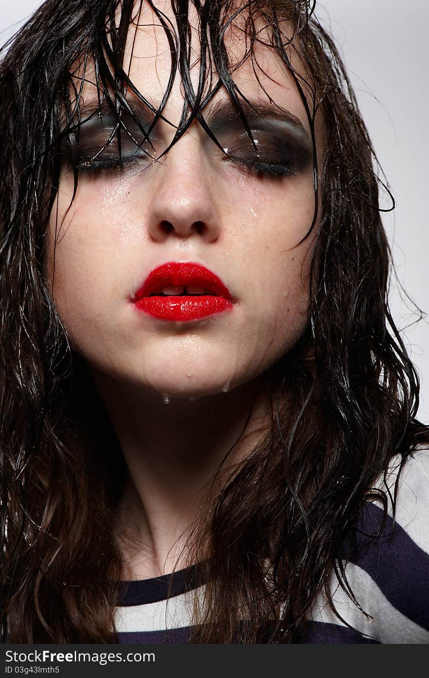 Close up portrait of beauty young girl with wet hairs and face with red glossy lipstick, bright makeup in studio. Close up portrait of beauty young girl with wet hairs and face with red glossy lipstick, bright makeup in studio