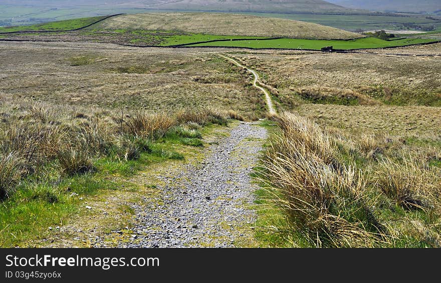 English hilly countryside: footpath, grassy fields