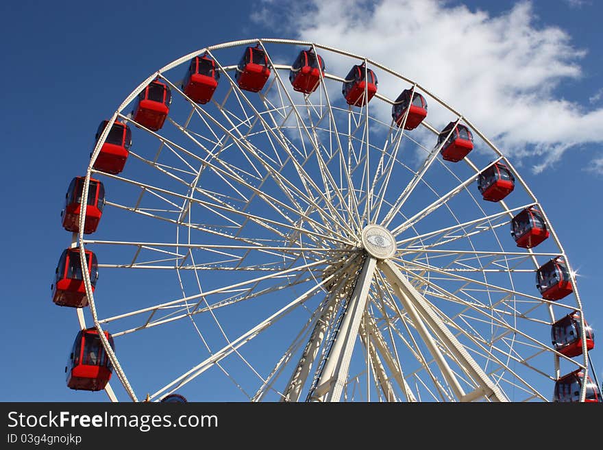 Red Carriages on a Large Fun Fair Big Wheel.