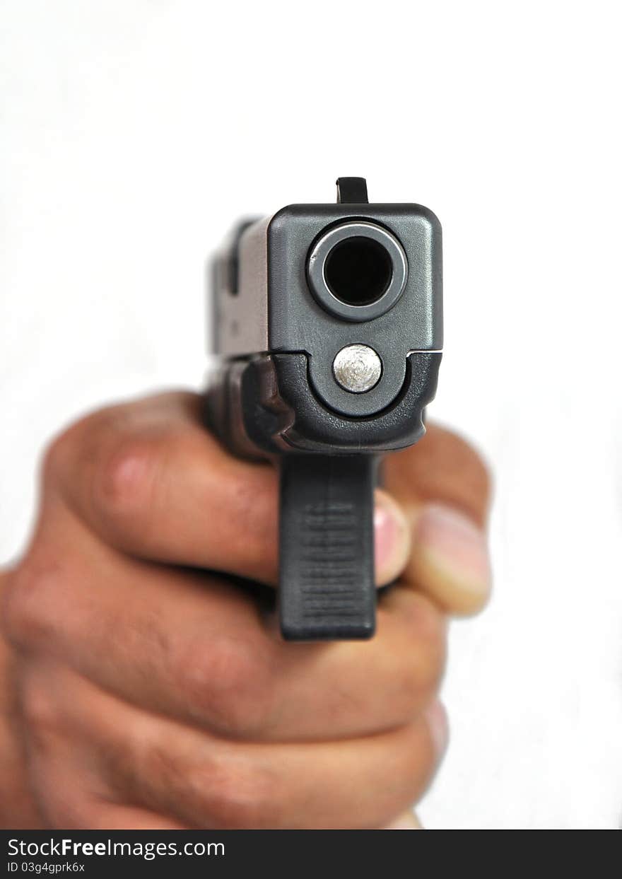 Pistol In A Man S Hand On A White Background.