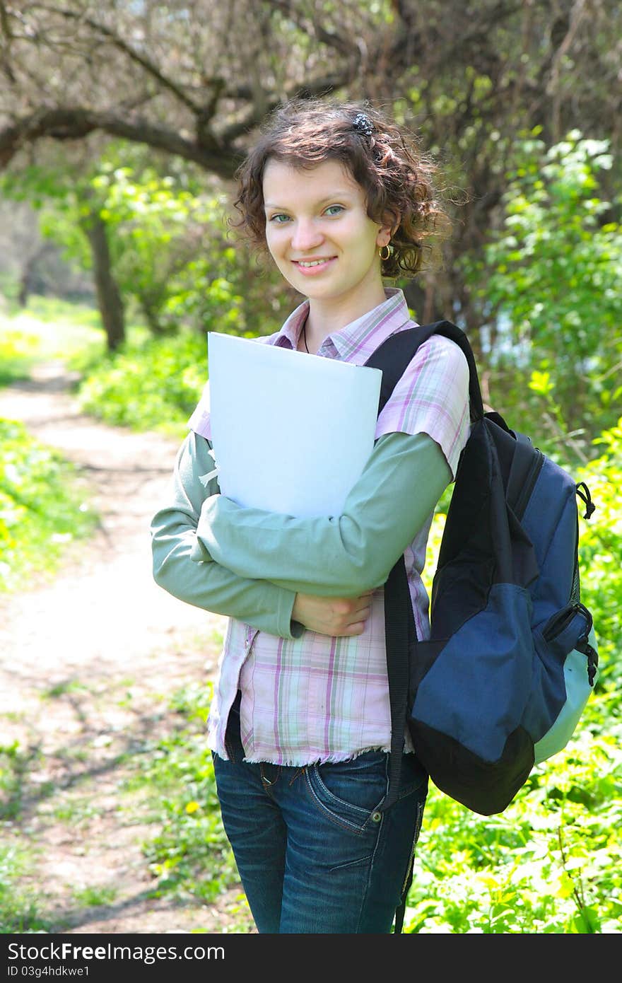 Female Teenage Student In summer Park