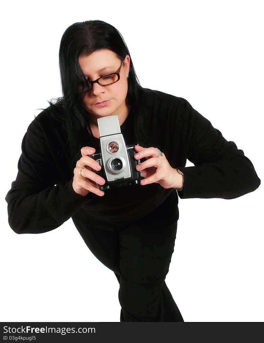 Woman wearing black taking picture with old camera on a white background