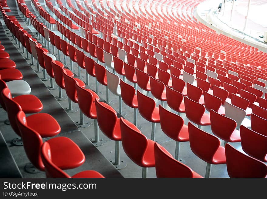 A red and white chair with number array in stadium. A red and white chair with number array in stadium.